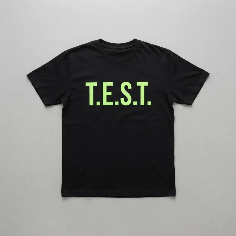 Black tee printed with “T.E.S.T.” in electric lime
